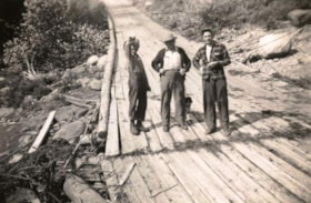 Austin Goodenough, manager, Henry Dreseler, pole inspector, and third man with small dog on wooden plank road. (Images are provided for educational and research purposes only. Other use requires permission, please contact the Museum.) thumbnail