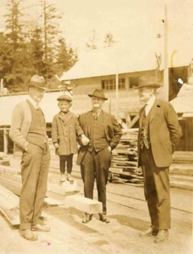 Group photo of three men and a young boy, Andimaul, B.C.. (Images are provided for educational and research purposes only. Other use requires permission, please contact the Museum.) thumbnail