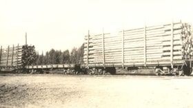 Flatbed rail cars loaded with timber. (Images are provided for educational and research purposes only. Other use requires permission, please contact the Museum.) thumbnail