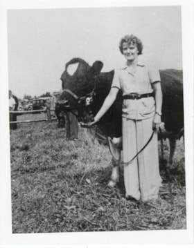 Lottie Oliarney and her show cow, Ruth, at the Fall Fair.. (Images are provided for educational and research purposes only. Other use requires permission, please contact the Museum.) thumbnail