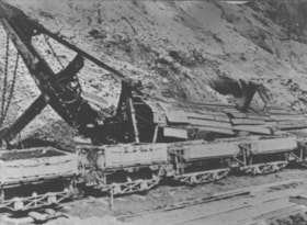 Steam shovel on its side during a mud slide.. (Images are provided for educational and research purposes only. Other use requires permission, please contact the Museum.) thumbnail