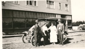 Charlie and Katie Chapman, [?] and [?] posing in front of a car in front of the Bulkley Hotel, Smithers, B.C.. (Images are provided for educational and research purposes only. Other use requires permission, please contact the Museum.) thumbnail