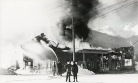 Firefighters putting out a fire at O'Neill's garage.. (Images are provided for educational and research purposes only. Other use requires permission, please contact the Museum.) thumbnail