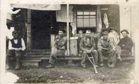 Five unidentified men outside a cabin.. (Images are provided for educational and research purposes only. Other use requires permission, please contact the Museum.) thumbnail