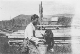 William Billeter hand-feeding a dairy calf. (Images are provided for educational and research purposes only. Other use requires permission, please contact the Museum.) thumbnail
