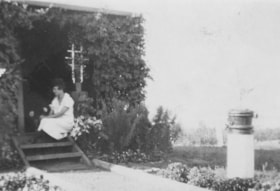 Florence Billeter arranging flowers on doorstep. (Images are provided for educational and research purposes only. Other use requires permission, please contact the Museum.) thumbnail