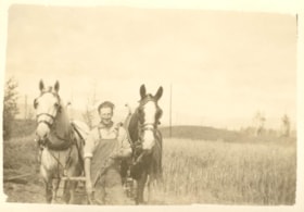 William Billeter standing with two work horses. (Images are provided for educational and research purposes only. Other use requires permission, please contact the Museum.) thumbnail
