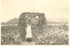Florence Billeter stands under the garden flower gate. (Images are provided for educational and research purposes only. Other use requires permission, please contact the Museum.) thumbnail