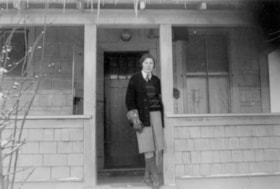 Vina Eby standing on the porch of a house. (Images are provided for educational and research purposes only. Other use requires permission, please contact the Museum.) thumbnail