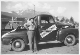 Austin Goodenough standing beside a Hanson Lumber & Timber Co. truck. (Images are provided for educational and research purposes only. Other use requires permission, please contact the Museum.) thumbnail