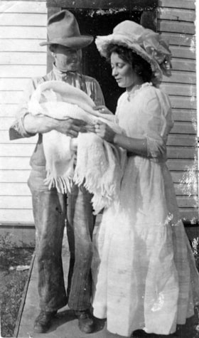 Charlie and Katie Chapman, holding their godchild. (Images are provided for educational and research purposes only. Other use requires permission, please contact the Museum.) thumbnail