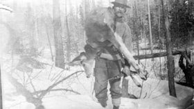 Man carrying a deer out of the bush. (Images are provided for educational and research purposes only. Other use requires permission, please contact the Museum.) thumbnail