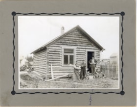 Nick Green and two unidentified men standing in front of a log cabin on Alfred Avenue, Smithers, B.C.. (Images are provided for educational and research purposes only. Other use requires permission, please contact the Museum.) thumbnail
