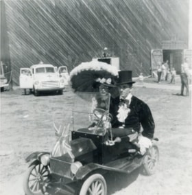 A man and lady sitting in a miniature car for the parade. (Images are provided for educational and research purposes only. Other use requires permission, please contact the Museum.) thumbnail