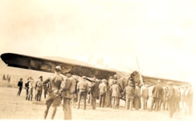 Group gathered around a plane that landed. (Images are provided for educational and research purposes only. Other use requires permission, please contact the Museum.) thumbnail
