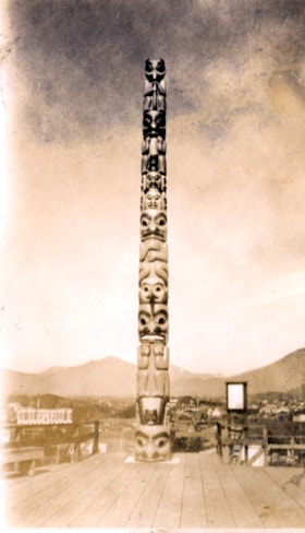 Totem pole on a wooden platform. (Images are provided for educational and research purposes only. Other use requires permission, please contact the Museum.) thumbnail