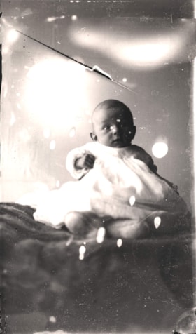 Angus McLean Jr. sitting on a blanket. (Images are provided for educational and research purposes only. Other use requires permission, please contact the Museum.) thumbnail