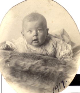 Lily Jones' baby lying on a fur throw.. (Images are provided for educational and research purposes only. Other use requires permission, please contact the Museum.) thumbnail