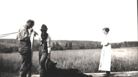 Three unidentified people and a deceased bear.. (Images are provided for educational and research purposes only. Other use requires permission, please contact the Museum.) thumbnail