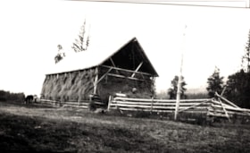 Men piling hay into barn at Jack McNeil's ranch, Telkwa, B.C.. (Images are provided for educational and research purposes only. Other use requires permission, please contact the Museum.) thumbnail