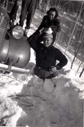 Unidentified man stuck in snow with unidentified woman throwing snow on his head. (Images are provided for educational and research purposes only. Other use requires permission, please contact the Museum.) thumbnail