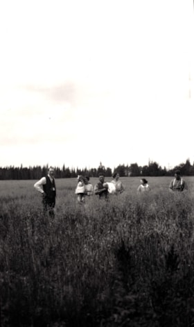 Group photo in hay field. (Images are provided for educational and research purposes only. Other use requires permission, please contact the Museum.) thumbnail