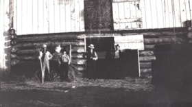 Four men standing outside hay barn. (Images are provided for educational and research purposes only. Other use requires permission, please contact the Museum.) thumbnail