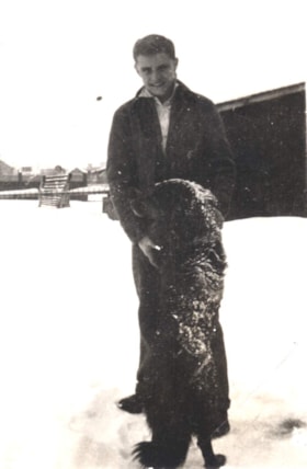 Jack Hetherington with a dog. (Images are provided for educational and research purposes only. Other use requires permission, please contact the Museum.) thumbnail