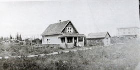 House with people on the front porch.. (Images are provided for educational and research purposes only. Other use requires permission, please contact the Museum.) thumbnail