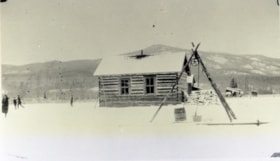 Log building with well in front. (Images are provided for educational and research purposes only. Other use requires permission, please contact the Museum.) thumbnail