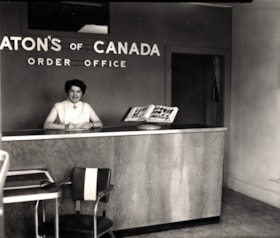 Alice O'Neill at front desk of Eaton's of Canada Order Office. (Images are provided for educational and research purposes only. Other use requires permission, please contact the Museum.) thumbnail