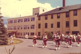 Bagpipers marching in front of Bulkley Valley District Hospital. (Images are provided for educational and research purposes only. Other use requires permission, please contact the Museum.) thumbnail