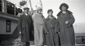 Four unidentified people on ferry deck. (Images are provided for educational and research purposes only. Other use requires permission, please contact the Museum.) thumbnail