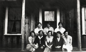 Eight young women on a porch. (Images are provided for educational and research purposes only. Other use requires permission, please contact the Museum.) thumbnail