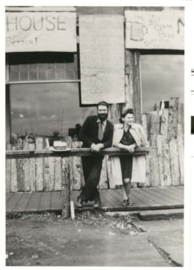 Unidentified man and woman in front of a store. (Images are provided for educational and research purposes only. Other use requires permission, please contact the Museum.) thumbnail