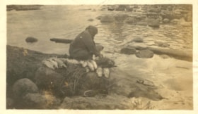 Indigenous woman cleaning salmon at Moricetown Canyon. (Images are provided for educational and research purposes only. Other use requires permission, please contact the Museum.) thumbnail