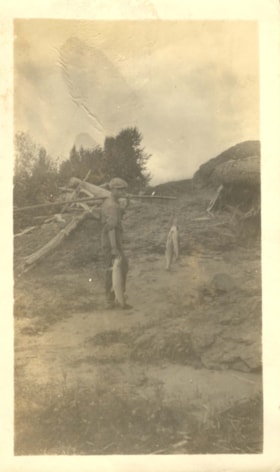 Indigenous youth carrying salmon. (Images are provided for educational and research purposes only. Other use requires permission, please contact the Museum.) thumbnail