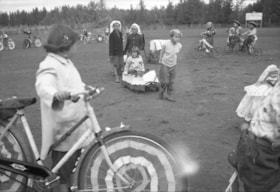 Children in [Elks] decorated bicycle and wagon parade. (Images are provided for educational and research purposes only. Other use requires permission, please contact the Museum.) thumbnail
