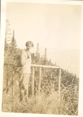 Woman standing by fence. (Images are provided for educational and research purposes only. Other use requires permission, please contact the Museum.) thumbnail