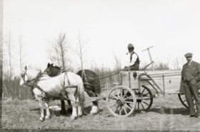 Joe Bourgon and unidentfied standing man with horses and cart. (Images are provided for educational and research purposes only. Other use requires permission, please contact the Museum.) thumbnail