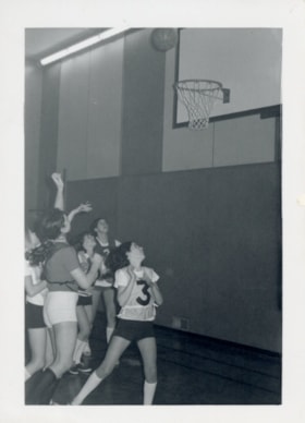 Attempted goal during girls' basketball game. (Images are provided for educational and research purposes only. Other use requires permission, please contact the Museum.) thumbnail