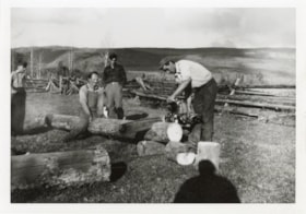 Four men cutting wood. (Images are provided for educational and research purposes only. Other use requires permission, please contact the Museum.) thumbnail