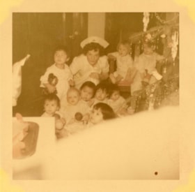 Bulkley Valley District Hospital Christmas, nurse with children. (Images are provided for educational and research purposes only. Other use requires permission, please contact the Museum.) thumbnail