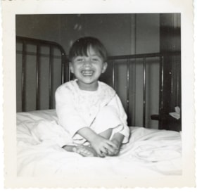 Bulkley Valley District Hospital, indigenous child sitting in bed. (Images are provided for educational and research purposes only. Other use requires permission, please contact the Museum.) thumbnail