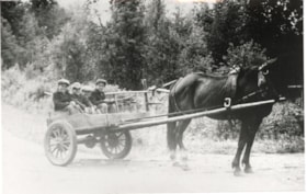 Steve Mesich, Ronnie Gilbert, Tony Mesich, and Emil Mesich riding in a horse drawn cart. (Images are provided for educational and research purposes only. Other use requires permission, please contact the Museum.) thumbnail