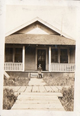 Jimmy Johnson in front of the Aida family home. (Images are provided for educational and research purposes only. Other use requires permission, please contact the Museum.) thumbnail