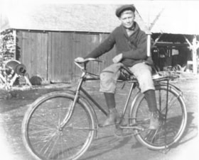 Dick Gilbert on a bike. (Images are provided for educational and research purposes only. Other use requires permission, please contact the Museum.) thumbnail