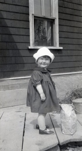 Child on porch. (Images are provided for educational and research purposes only. Other use requires permission, please contact the Museum.) thumbnail