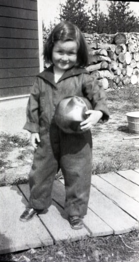 Child holding a ball. (Images are provided for educational and research purposes only. Other use requires permission, please contact the Museum.) thumbnail