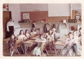 Girls wearing pioneer dresses in classroom. (Images are provided for educational and research purposes only. Other use requires permission, please contact the Museum.) thumbnail